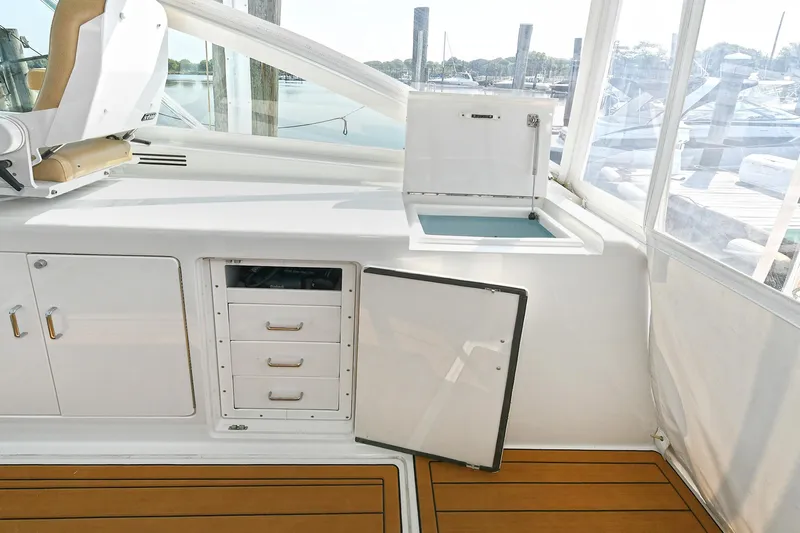  Yacht Photos Pics 1999 Cabo 45 Express boat interior with storage compartments and open hatch.