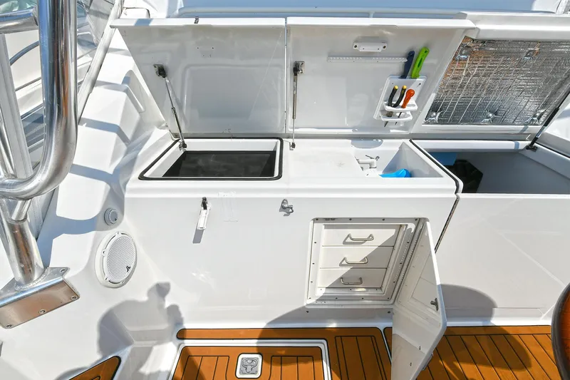  Yacht Photos Pics 1999 Cabo 45 Express boat galley with storage, sink, and teak flooring.