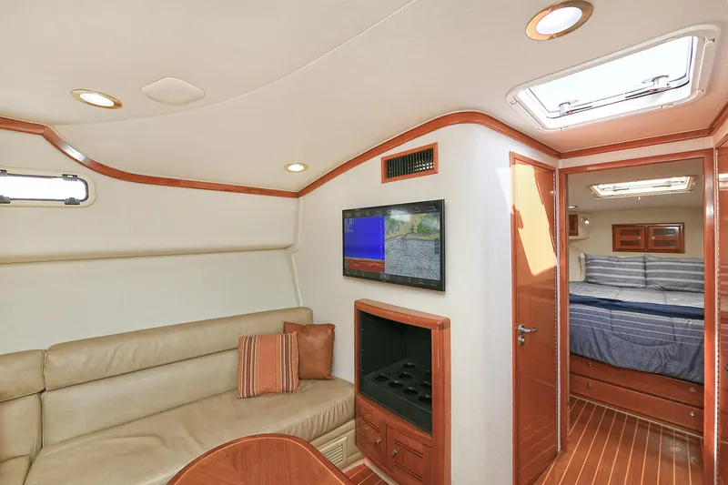  Yacht Photos Pics Interior of 1999 Cabo 45 Express yacht with cozy seating and modern amenities.