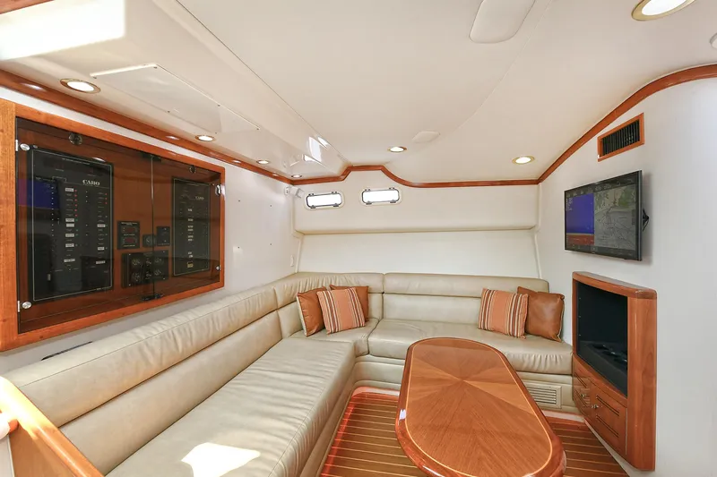  Yacht Photos Pics Luxurious interior of 1999 Cabo 45 Express yacht with leather seating and wood accents.