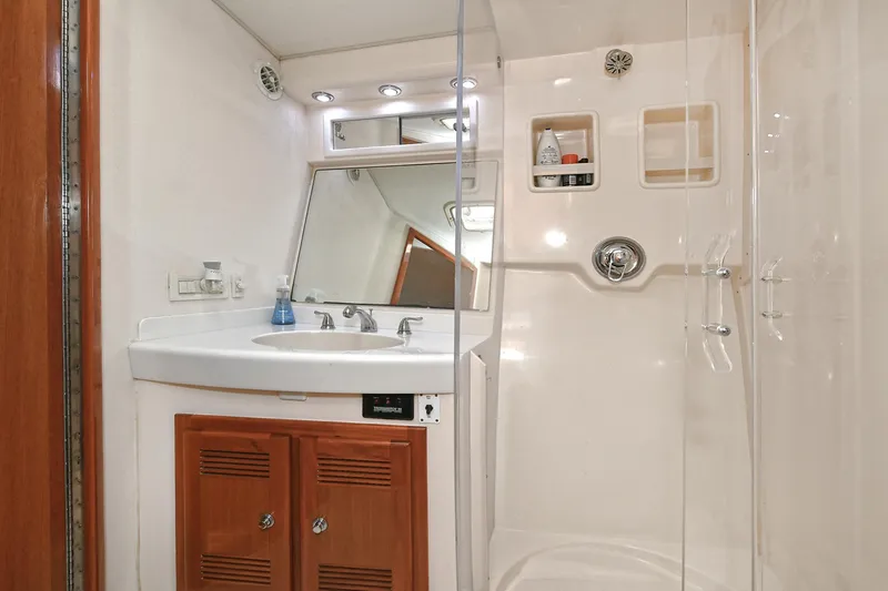  Yacht Photos Pics Bathroom interior of 1999 Cabo 45 Express yacht with shower and vanity.