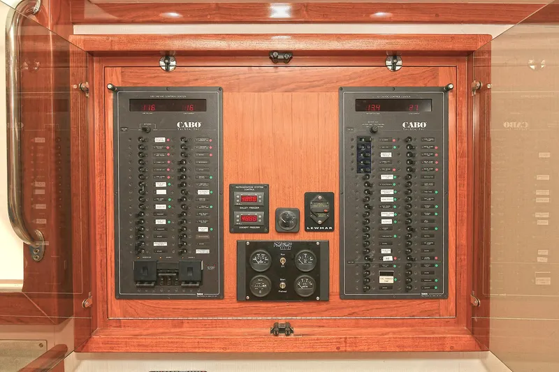  Yacht Photos Pics Electrical control panel on a 1999 Cabo 45 Express boat, featuring switches and gauges.