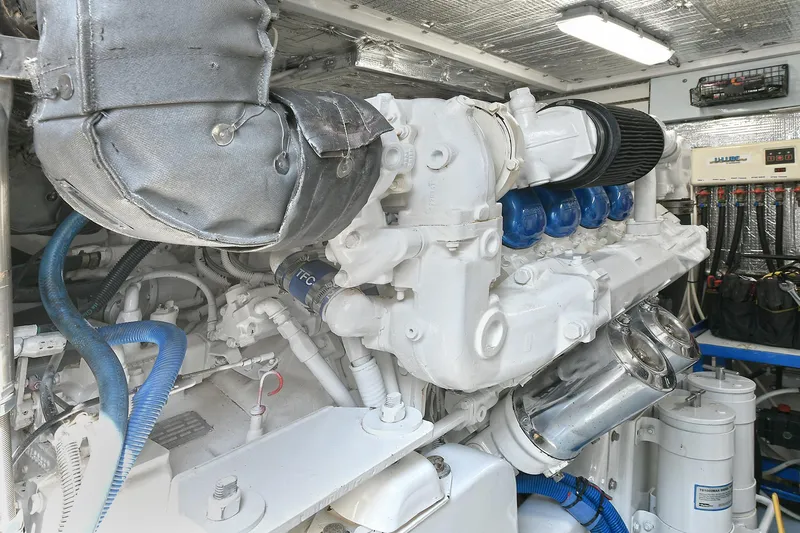  Yacht Photos Pics Engine room of a 1999 Cabo 45 Express yacht, showcasing a clean, well-maintained engine.