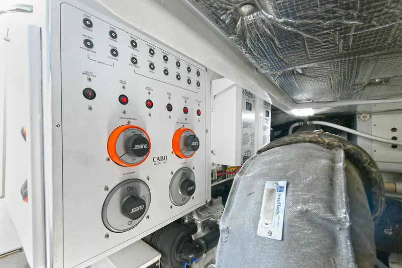  Yacht Photos Pics Control panel of a 1999 Cabo 45 Express boat engine room, featuring switches and dials.