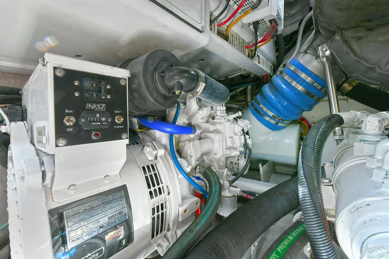  Yacht Photos Pics Engine room of a 1999 Cabo 45 Express boat, showcasing mechanical components and wiring.