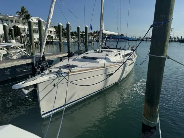 Levity Yacht Photos Pics 2019 Jeanneau Sun Odyssey 479 sailboat docked in a marina, clear sky, calm water.
