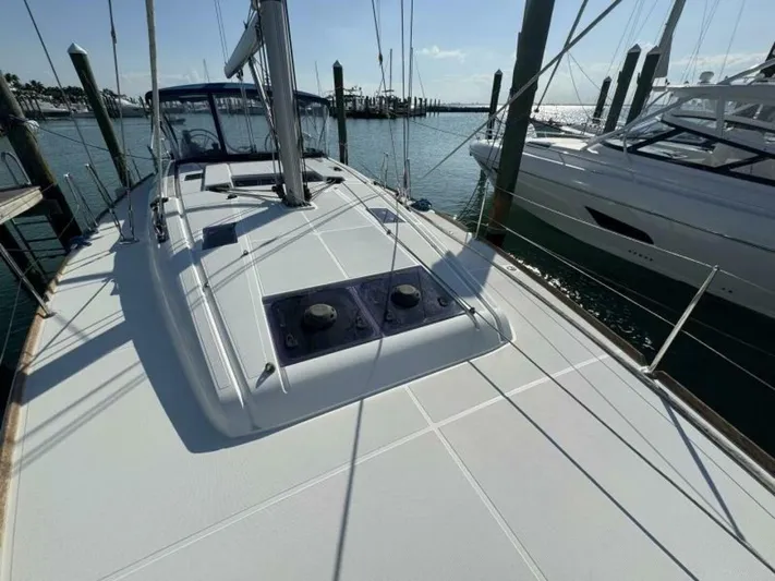 Levity Yacht Photos Pics 2019 Jeanneau Sun Odyssey 479 sailboat docked at marina, sunny day.