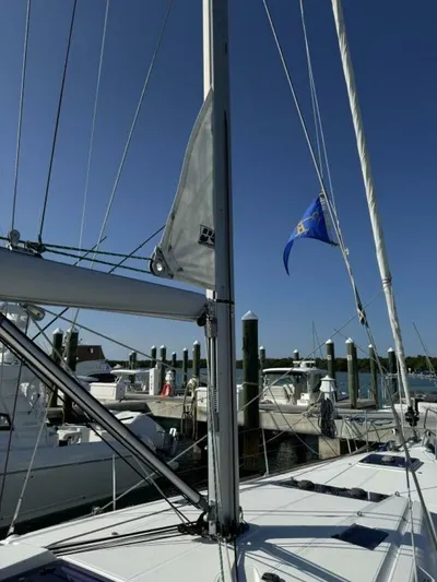 Levity Yacht Photos Pics 2019 Jeanneau Sun Odyssey 479 sailboat docked at marina under clear blue sky.