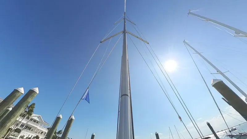 Levity Yacht Photos Pics 2019 Jeanneau Sun Odyssey 479 sailboat mast against clear blue sky at marina.