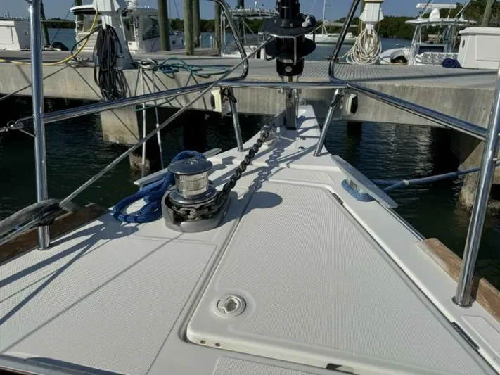 Levity Yacht Photos Pics 2019 Jeanneau Sun Odyssey 479 yacht bow at marina, featuring anchor chain and winch.