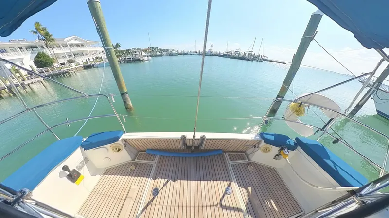 Levity Yacht Photos Pics 2019 Jeanneau Sun Odyssey 479 yacht docked in a serene marina setting.