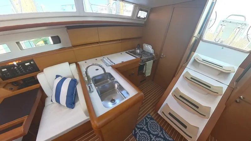 Levity Yacht Photos Pics Interior of 2019 Jeanneau Sun Odyssey 479 yacht with kitchen and seating area.