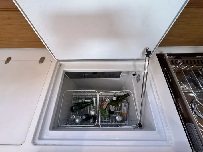 Levity Yacht Photos Pics Open fridge on Jeanneau Sun Odyssey 479 yacht, stocked with beverages.