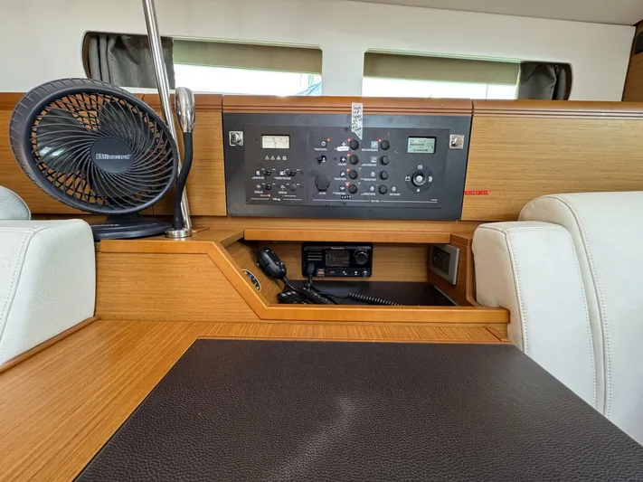 Levity Yacht Photos Pics 2019 Jeanneau Sun Odyssey 479 interior with control panel and fan.