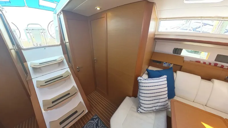 Levity Yacht Photos Pics Interior of 2019 Jeanneau Sun Odyssey 479 yacht, featuring cozy seating and wooden finishes.