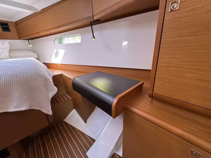 Levity Yacht Photos Pics 2019 Jeanneau Sun Odyssey 479 cabin interior with wooden finish and cozy bed.