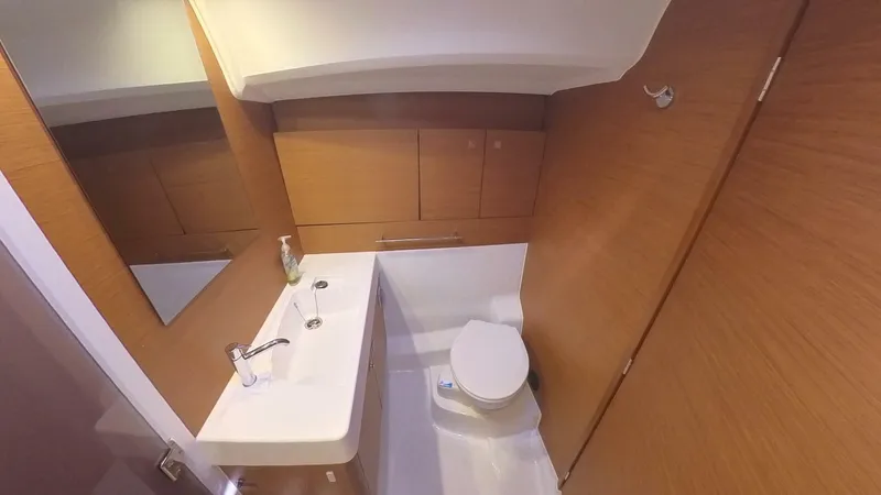 Levity Yacht Photos Pics 2019 Jeanneau Sun Odyssey 479 bathroom with modern fixtures and wooden cabinetry.