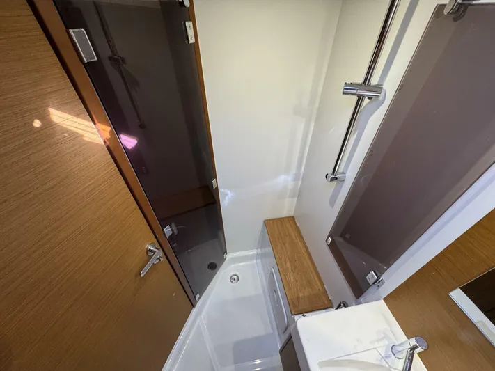 Levity Yacht Photos Pics Bathroom interior of 2019 Jeanneau Sun Odyssey 479 yacht, featuring modern fixtures and wooden accents.