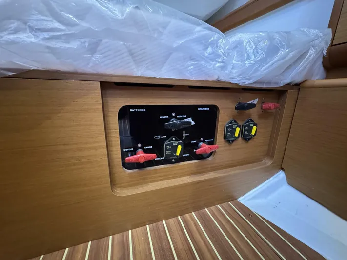 Levity Yacht Photos Pics Control panel on 2019 Jeanneau Sun Odyssey 479 yacht, featuring battery switches and wooden interior.
