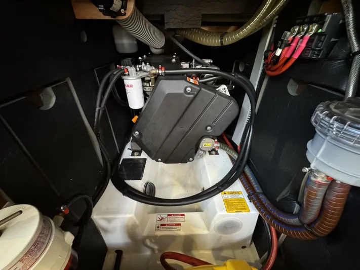 Levity Yacht Photos Pics Engine compartment of 2019 Jeanneau Sun Odyssey 479 sailboat, showcasing mechanical components and wiring.