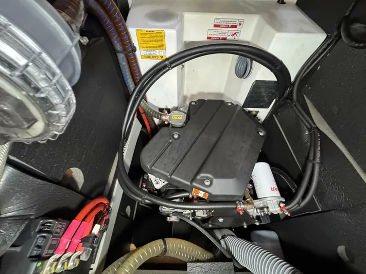 Levity Yacht Photos Pics Engine compartment of 2019 Jeanneau Sun Odyssey 479 sailboat, showcasing mechanical components and wiring.