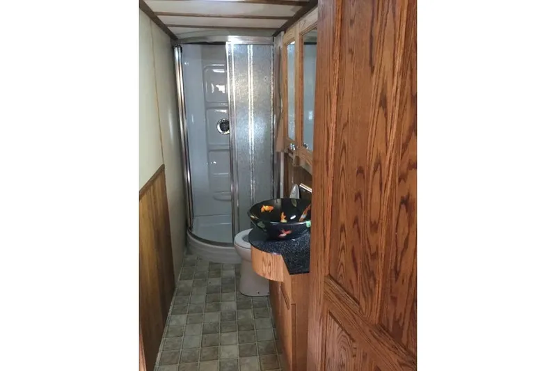 Horus Yacht Photos Pics Bathroom interior of 2013 Custom Trawler 45 with wood cabinetry and modern shower.