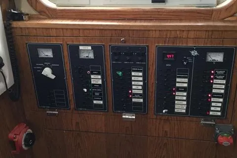 Horus Yacht Photos Pics Control panel of a 2013 Custom Trawler 45 with various switches and gauges.