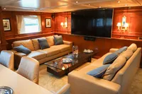 Luxurious yacht interior with plush seating, large TV, and elegant wooden paneling, 1966 Custom Global Engineering.