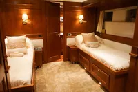 Luxurious twin cabin with wooden decor and soft lighting, aboard a 1966 Custom GLOBAL ENGINEERING yacht.