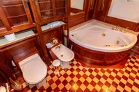 Luxurious vintage bathroom with wood paneling, corner bathtub, and checkered floor tiles, 1966 design.