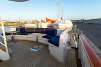 Luxury yacht deck with curved seating, wooden flooring, and marina view, Custom GLOBAL ENGINEERING 1966.