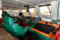 Interior of 1966 Custom GLOBAL ENGINEERING boat with green leather seats and navigation equipment.