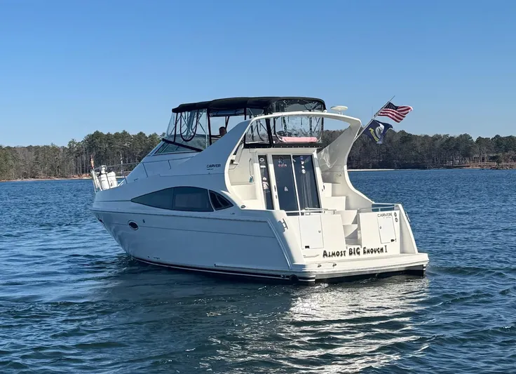  Yacht Photos Pics 2004 Carver 360 Mariner yacht on a serene lake with American flag.