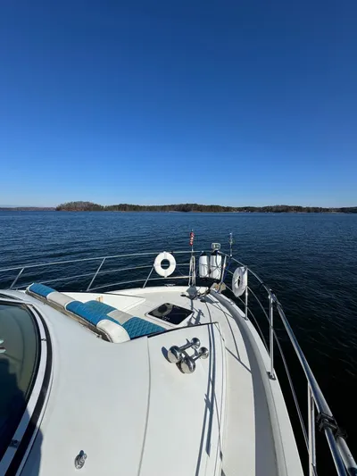  Yacht Photos Pics 2004 Carver 360 Mariner yacht cruising on a serene lake under a clear blue sky.