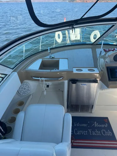  Yacht Photos Pics 2004 Carver 360 Mariner yacht interior with seating, sink, and mini-fridge on a lake.