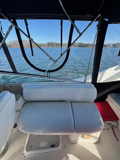  Yacht Photos Pics Interior view of 2004 Carver 360 Mariner boat with white seating and lake backdrop.