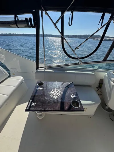  Yacht Photos Pics Interior of 2004 Carver 360 Mariner yacht with nautical-themed table, overlooking serene water.