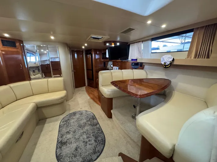  Yacht Photos Pics 2004 Carver 360 Mariner interior with beige seating, wooden table, and modern amenities.