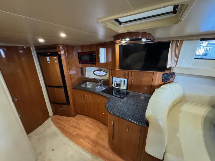  Yacht Photos Pics Interior of 2004 Carver 360 Mariner yacht with kitchenette and seating area.