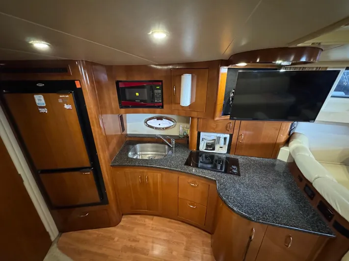  Yacht Photos Pics Interior of 2004 Carver 360 Mariner yacht kitchen with wood cabinetry and modern appliances.