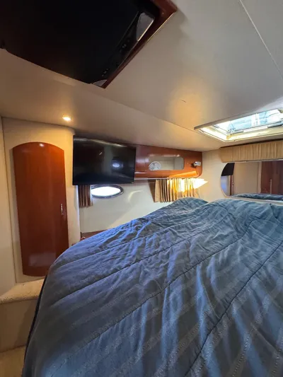  Yacht Photos Pics Interior of 2004 Carver 360 Mariner with cozy bed and wooden cabinetry.