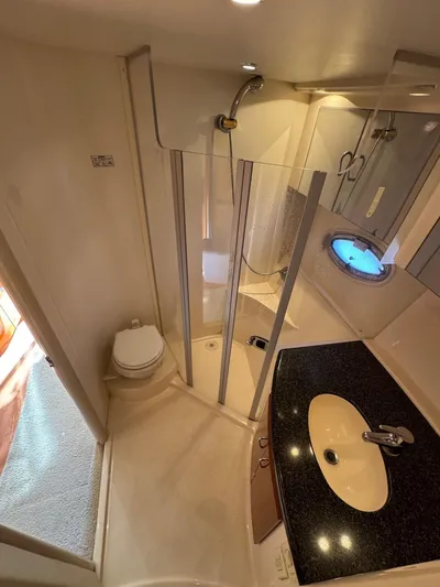  Yacht Photos Pics 2004 Carver 360 Mariner bathroom with shower, sink, and porthole window.