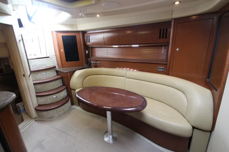 Yacht Photos Pics Interior of 2007 Sea Ray 44 Sundancer yacht with curved seating and wooden table.