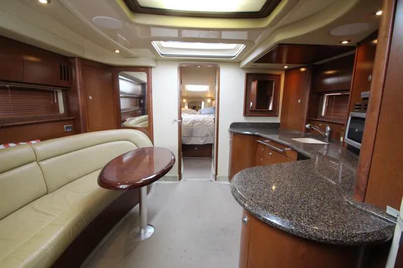  Yacht Photos Pics Luxurious interior of 2007 Sea Ray 44 Sundancer yacht with modern kitchen and seating area.