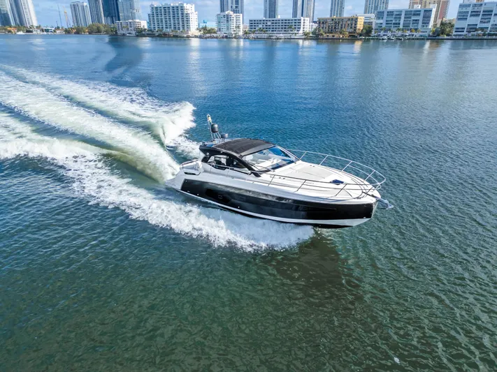  Yacht Photos Pics Azimut Atlantis 45 yacht cruising on water, city skyline in background, 2020 model.