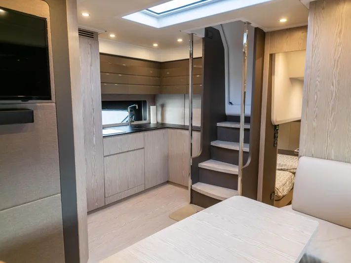  Yacht Photos Pics Luxurious interior of 2020 Azimut Atlantis 45 yacht with modern kitchen and staircase.