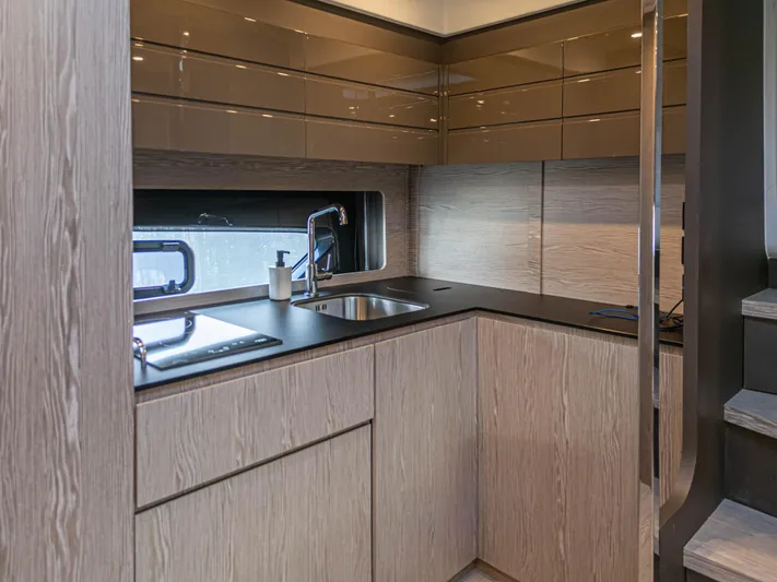  Yacht Photos Pics Modern kitchen interior of 2020 Azimut Atlantis 45 yacht, featuring sleek cabinetry and stainless steel sink.