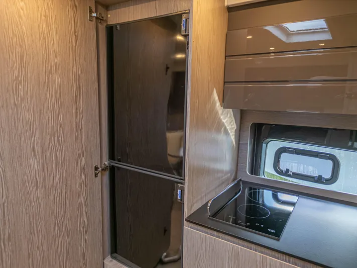  Yacht Photos Pics Modern kitchen interior of 2020 Azimut Atlantis 45 yacht with sleek cabinetry and appliances.