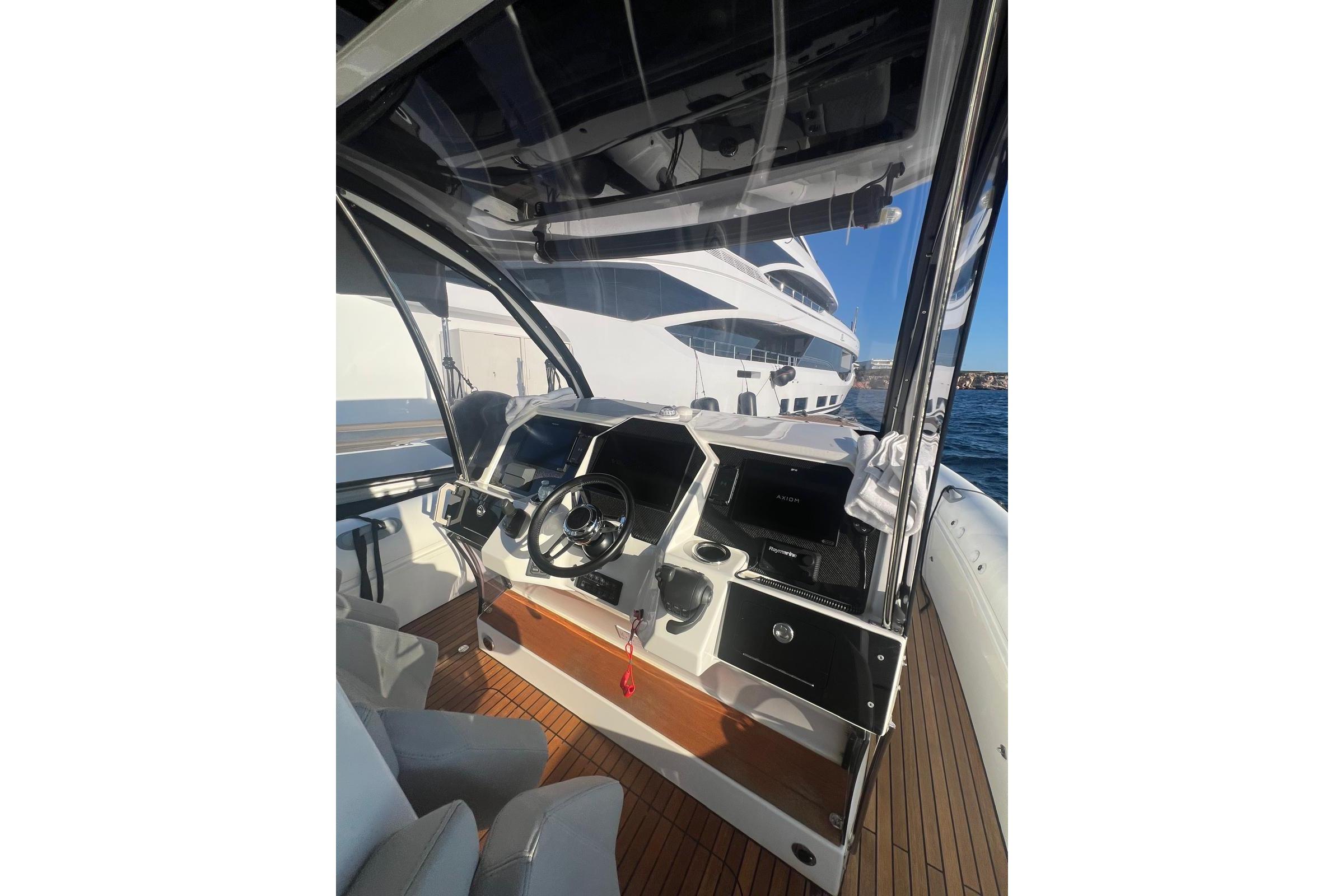Helm of 2022 Skipper NC 42 yacht with modern controls and ocean view.