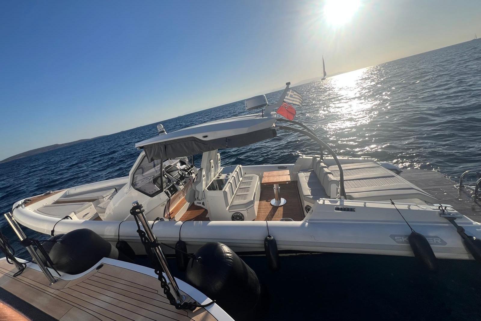 2022 Skipper NC 42 boat on calm sea at sunset, showcasing sleek design and luxury features.